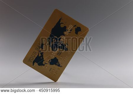 Close-up Of Personal Gold Plastic Credit Card, Cashless Contactless Payment Via Digital Carrier. Mon