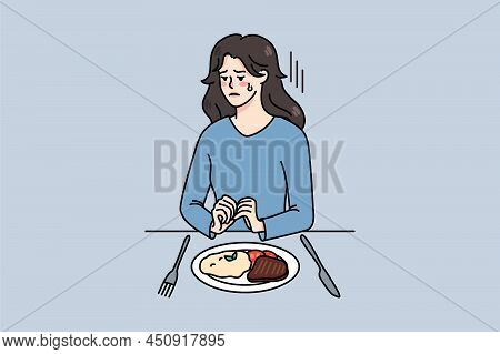 Unhappy Young Woman Sit At Table With Food Struggle With Eating Disorder. Upset Girl Refuse From Mea
