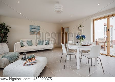 Radwinter, Essex - Sept 12 1018: Modern Furnished Dining Room With Table, Sofa,armchair, Footstool, 