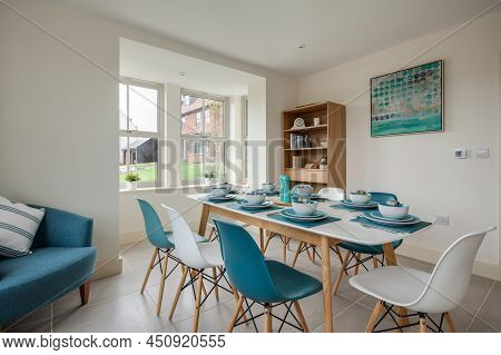 Radwinter, Essex - Sept 12 1018: Modern Furnished Bright Dining Room With Table Set With Turquoise C