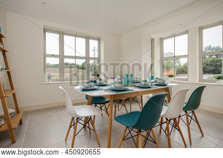Radwinter, Essex - Sept 12 1018: Modern Furnished Bright Dining Room With Table Set With Turquoise C