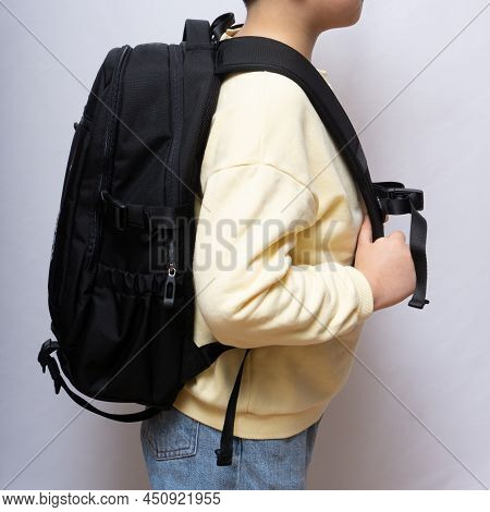 Asian Child Standing With A Black Backpack
