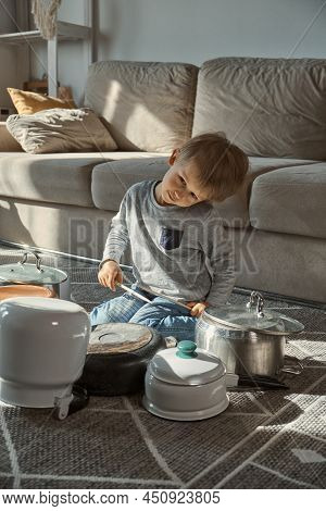 Child Drummer Having Fun Drum Playing On Kitchen Pans At Home