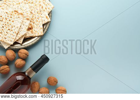 Passover Celebration Concept. Matzah, Red Kosher And Walnut. Traditional Ritual Jewish Bread On Blue