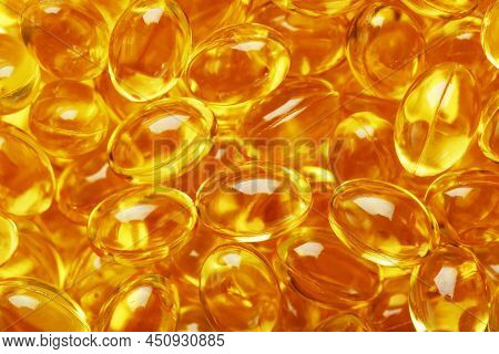 Golden Vitamin D3 Capsules Close-up In Full Screen