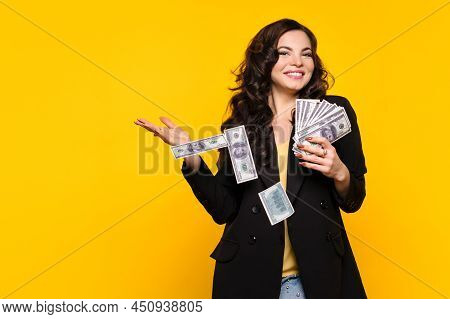 Rich Carefree Woman Squanders Money. Girl With Stack Of Cash One Hundred Dollar Bills In Black Jacke