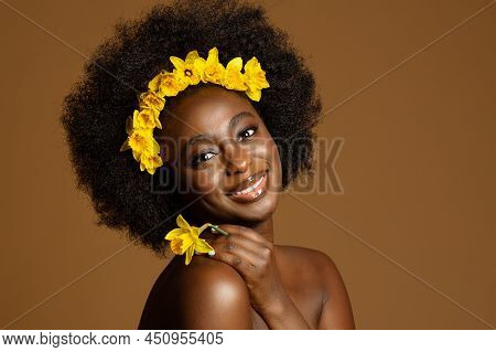 Black Woman Beauty With Yellow Flower. African Model With Curly Coily Hairstyle And Floral Wreath In