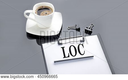 Loc Text On Paper Sheet With Coffee On Black Background