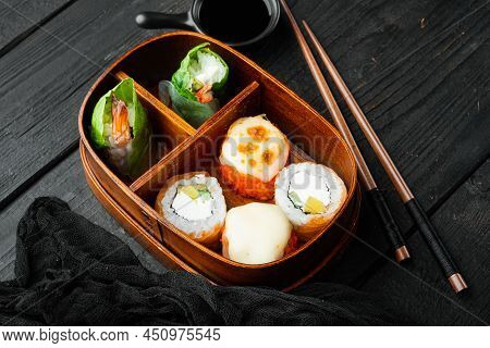 Japanese Meal In A Box Bento With Sushi Roll Eice Avocado Salmon Fish Set, On Black Wooden Table Bac