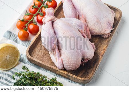 Raw Coquelet Chickens Meat With Herbs And Ingredients, On White Background