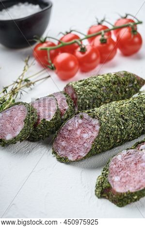 Traditianal Fuet Sausage In Herbs With Ingredients On White Textured Background.