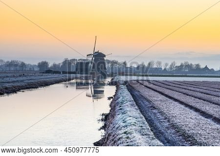 Breezand, The Netherlands. March 2022. Sunrise In The Polder With Mill In Background.