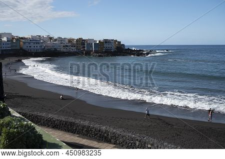 View On Colorful Houses And Black Lava Rocks In Small Village Punta Brava Near Puerto De La Cruz, Te
