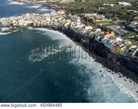 Aerial View On Colorful Houses And Black Lava Rocks In Small Village Punta Brava Near Puerto De La C
