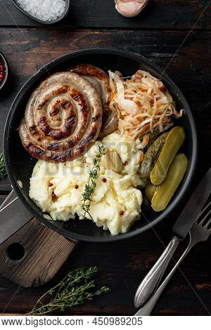 Fried Bavarian German Nürnberger Sausages With Sauerkraut, Mashed Potatoe In Cast Iron Frying Pan, O