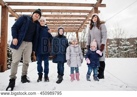 Big Young Family With Four Kids In Winter Day.