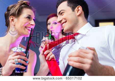 Woman flirting with barkeeper in cocktail bar