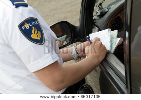 Policewoman Writes On Notebook