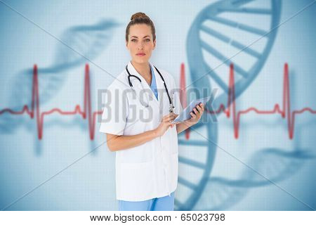 Pretty nurse using tablet pc against blue medical background with dna and ecg