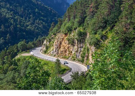 Narrow alpine highway in Alps, France (view from above).