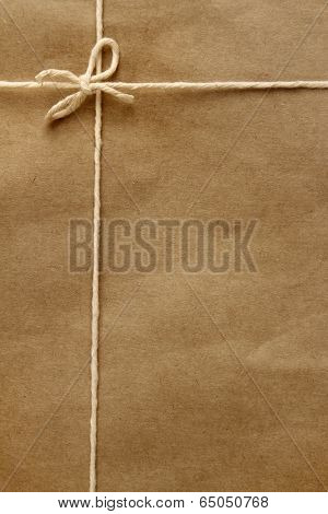 Tied knot on brown parcel