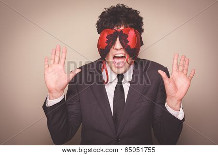 Businessman with a bra on his face