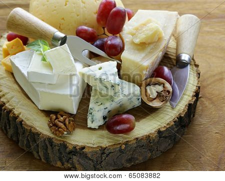 cheeseboard with assorted cheeses (parmesan, brie, blue, cheddar)