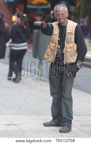 tattooed man is showing thumb