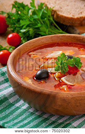 Soup solyanka Russian with meat, olives and gherkins