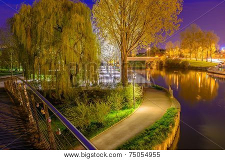 A Night in the Park. Late Spring Night in the Park. River and Park Alley. Horizontal Photography. Central Europe. France. Paris. Amiens.
