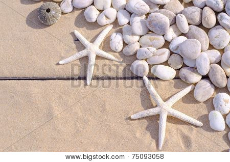Top View Of  Starfishs And White Stone On Sand Background