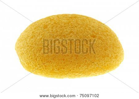 A round yellow natural facial Sponge made of vegetable fiber, Konjac, isolated on white