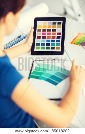 interior design, renovation and technology concept - woman working with color samples for selection