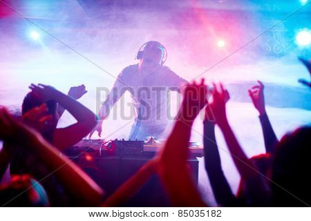Charismatic disc jockey at the turntable