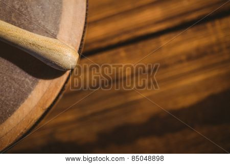 Traditional Irish bodhran and stick on wooden table
