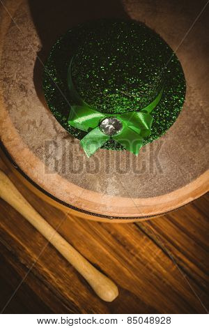 Traditional Irish bodhran and stick on wooden table