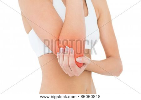 Closeup mid section of a fit young woman with elbow pain over white background