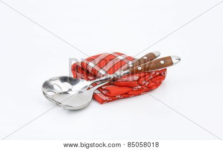 salad servers on red dishtowel