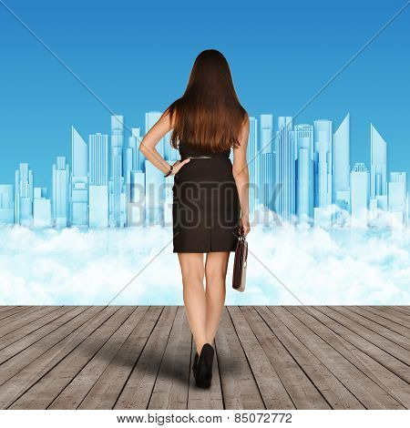 The girl goes to city skyscraper on blue clouds