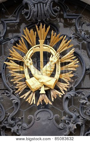 GRAZ, AUSTRIA - JANUARY 10, 2015: Franciscan monogram on the main entrance, Mariahilf church in Graz, Styria, Austria on January 10, 2015.