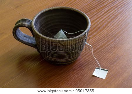 Clay cup with teabag.