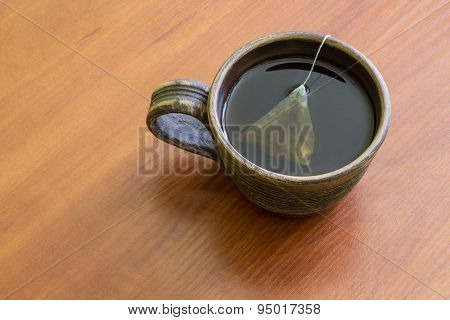 Clay Cup of tea with teabag.