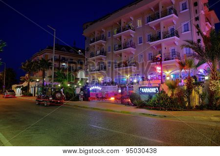 Nightlife In Resort Settlement, Colorful Lighting Building Facade Of Hotel.