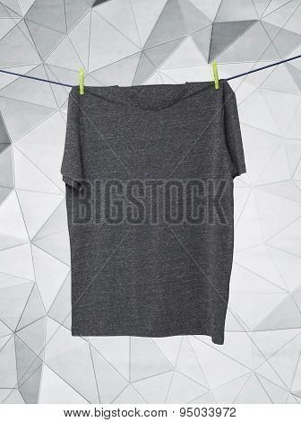 Close Up Of A Grey T-shirts On The Rope. Contemporary Background.