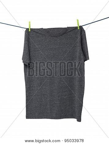 Close Up Of A Dark Grey T-shirts On The Rope. Isolated.