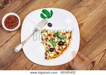 Slise of Pizza homemade with sauce on wooden background and arm