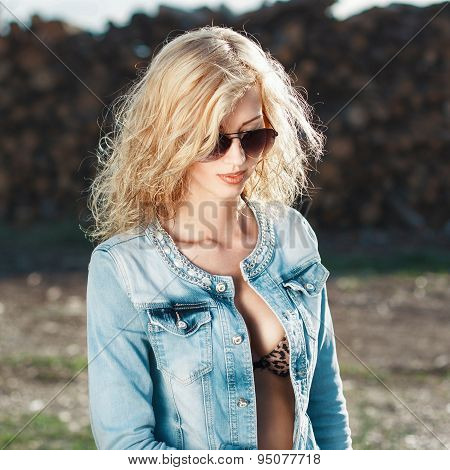 Portrait Of A Prety Woman In Sunglasses And Jeans Jacket.