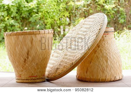 Basketwork contains earthenware steamer and threshing basket.