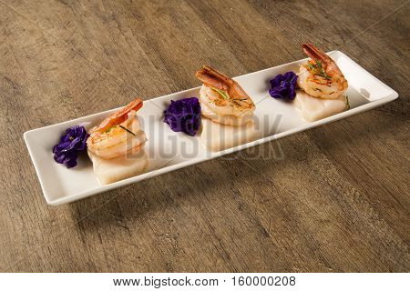 Grilled Shrimp With Raw Nail Fish On White Plate At Table