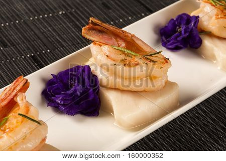 Grilled Shrimp With Raw Nail Fish On White Plate At Table
